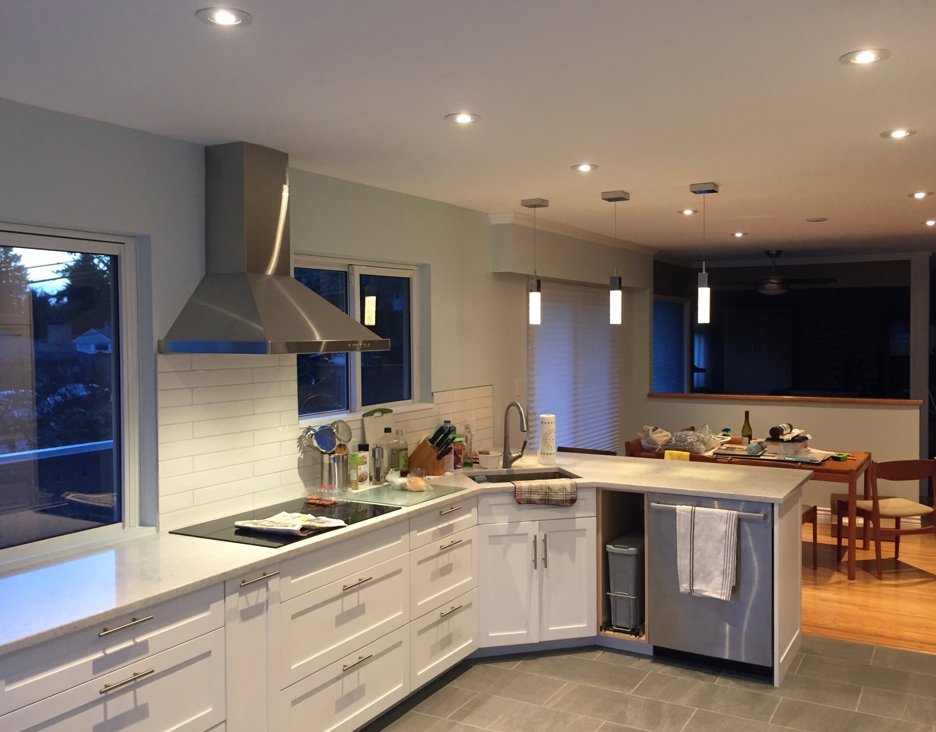Kitchen renovation with pot lights, pendant lights in open plan layout