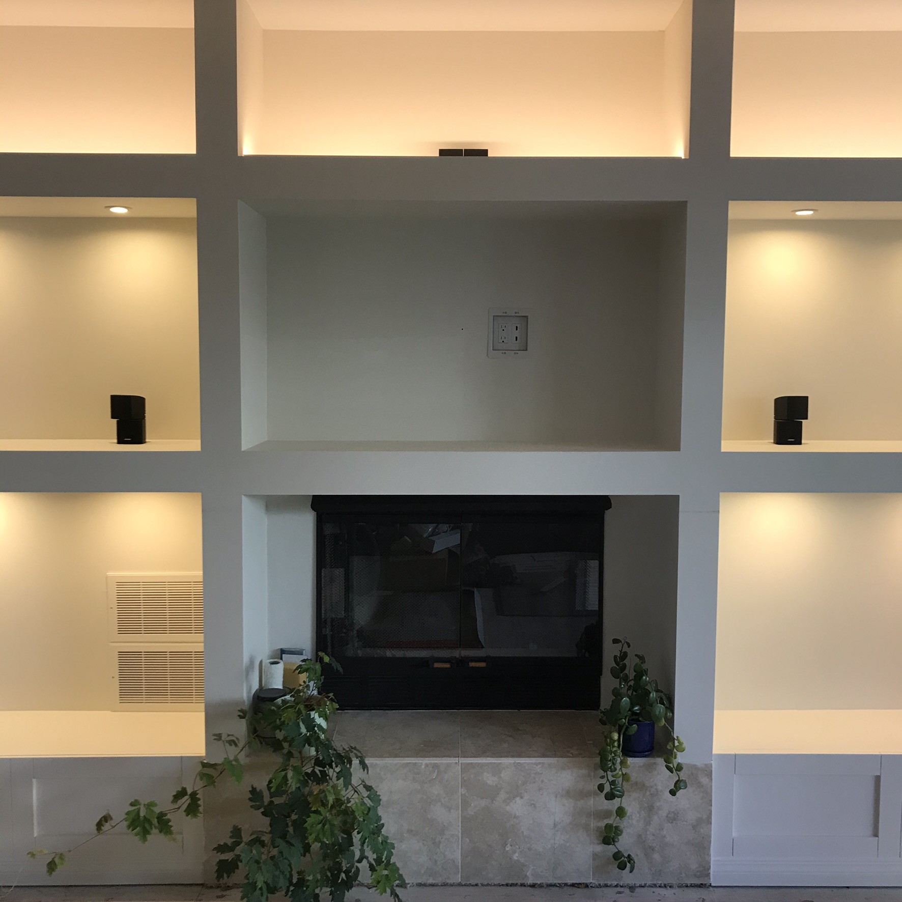 Built-in wall unit with electric fireplace and warm LED cove lighting