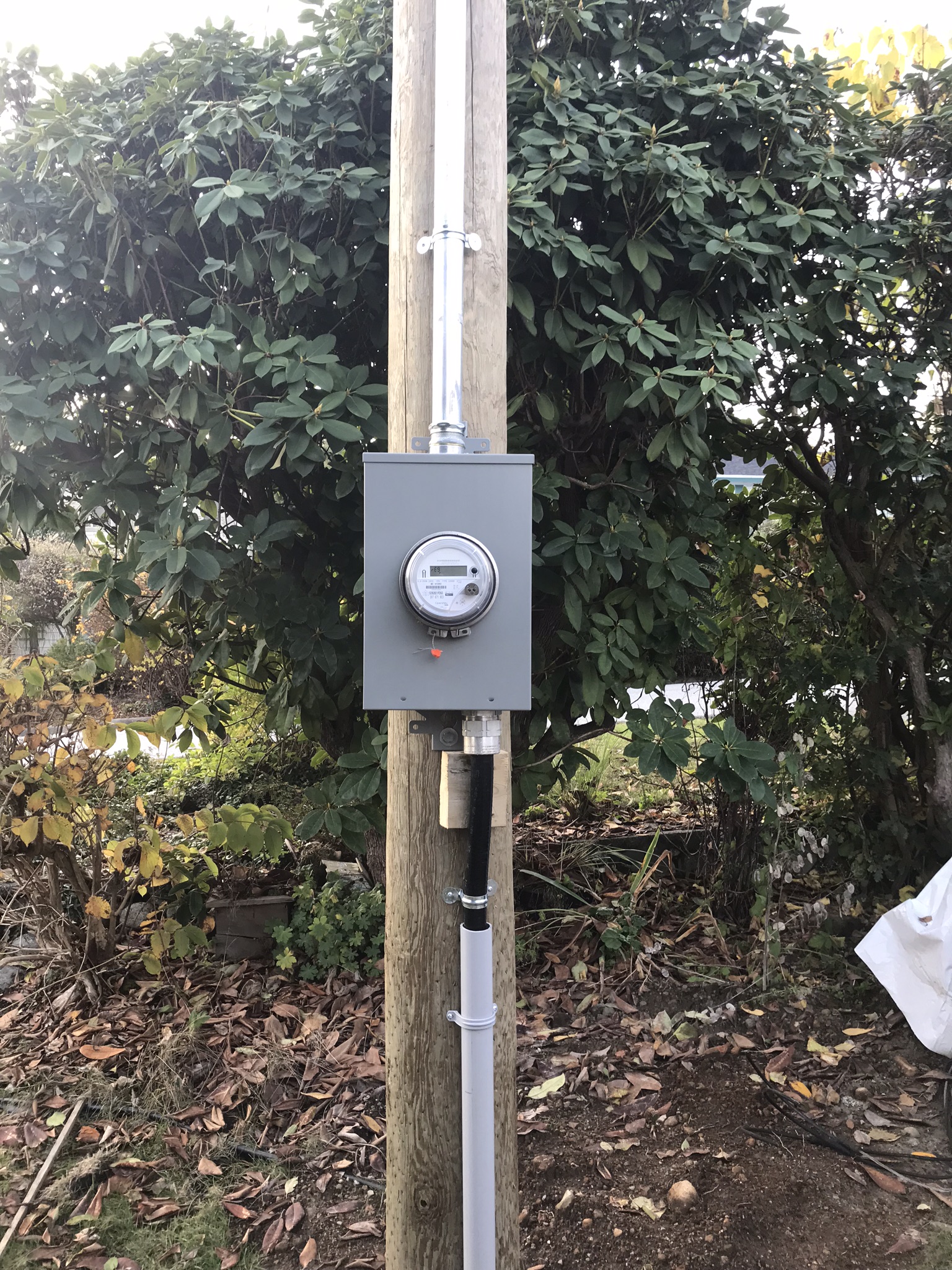 Meter base installed on wood post for exterior service entrance