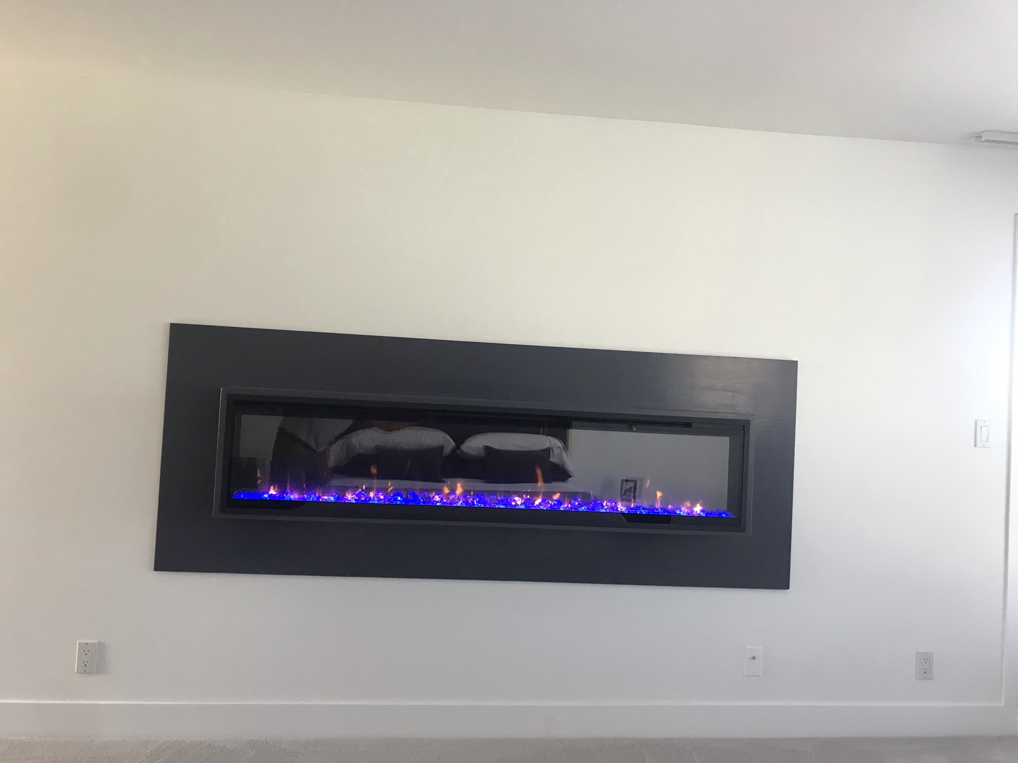 Linear electric fireplace built into feature wall