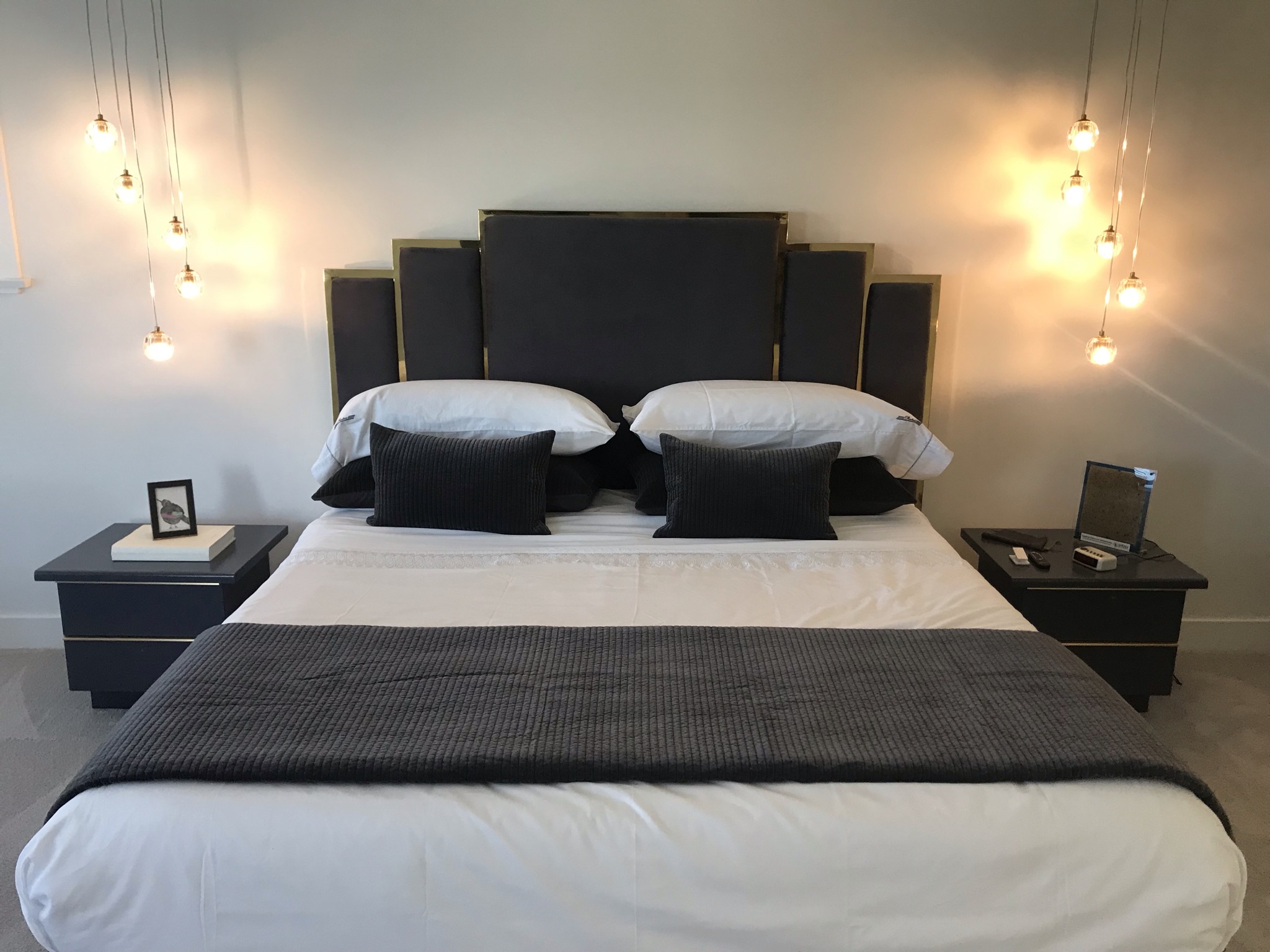Luxury master suite with cove LED ceiling lighting and dual pendants