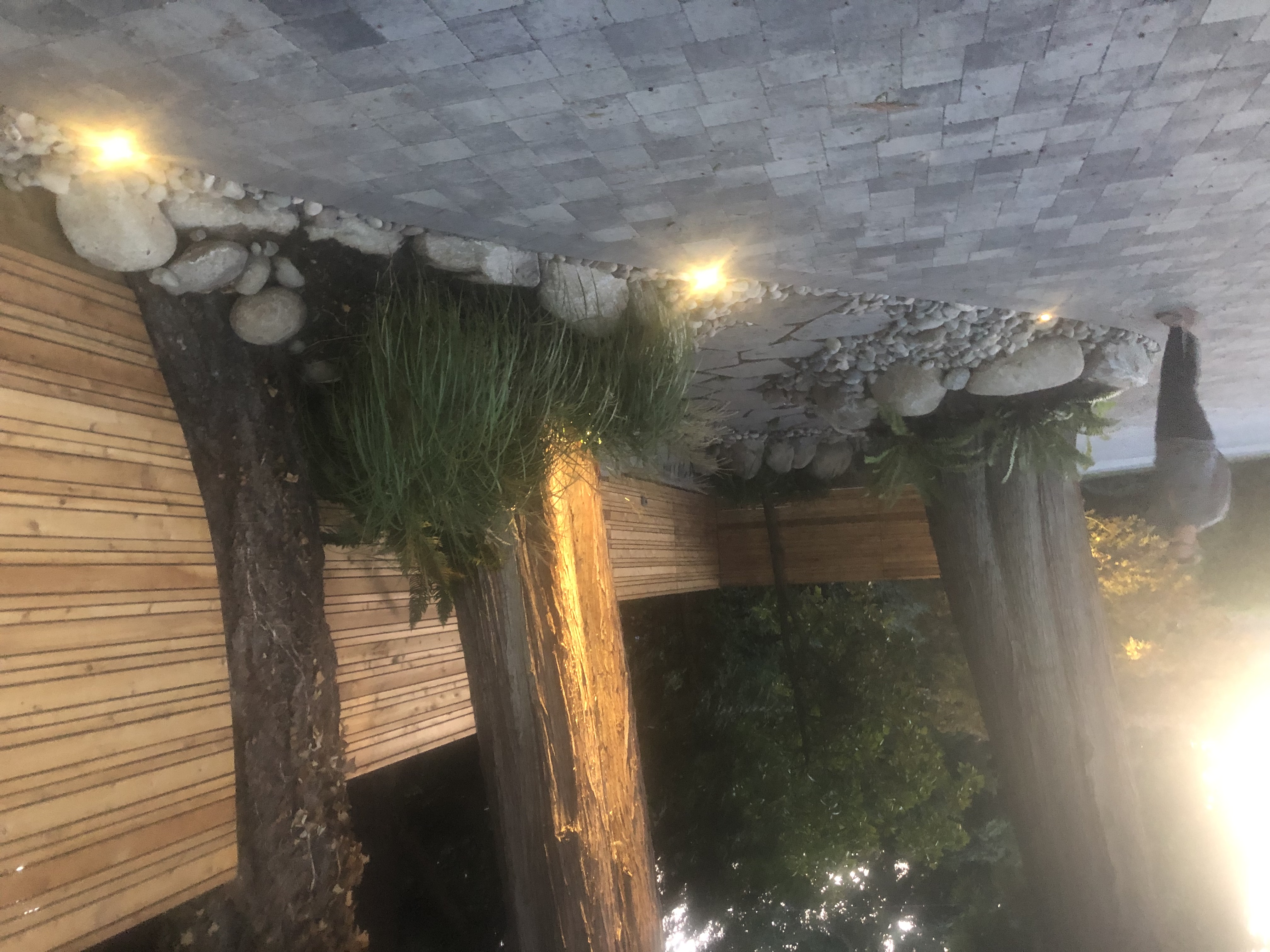 Unique outdoor structure with pot lights in pebble ceiling