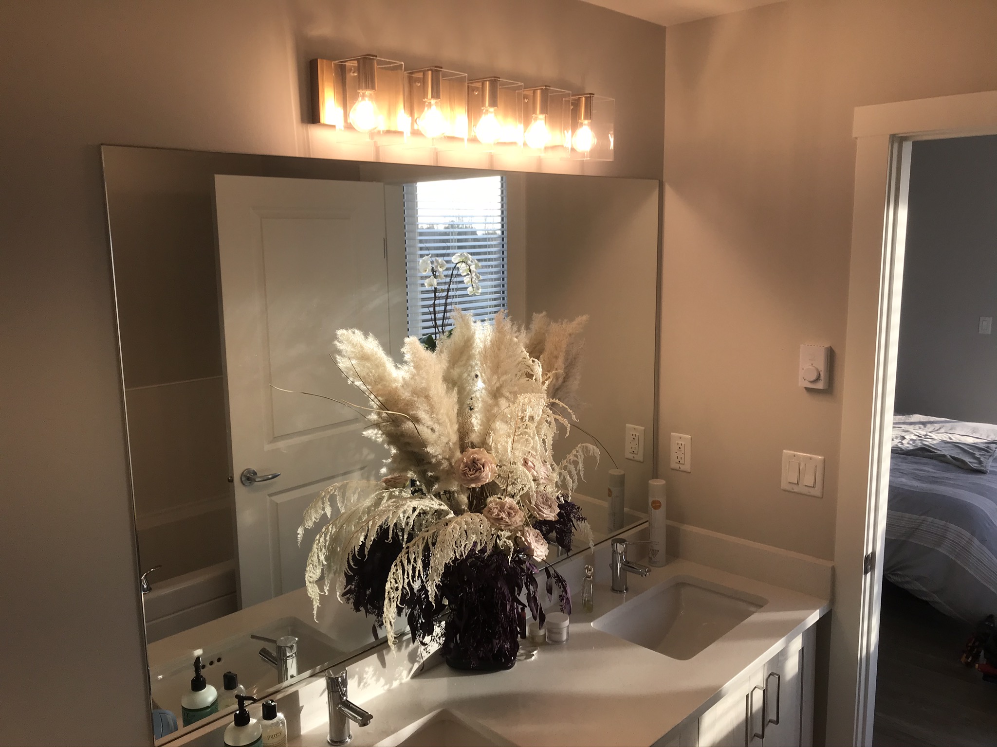 Elegant 6-globe bar light above bathroom vanity mirror